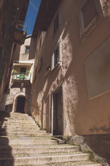 Narrow town street. Stone stairs between buildings. Old district of Stresa.