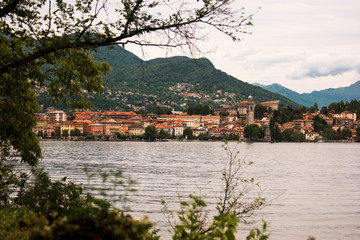 Water and town buildings. Sky and green mountains. Summer trip to Stresa.