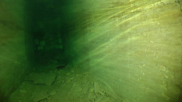 The camera moves to a deadlock in the roadway of a flooded mine.

