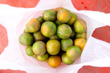 Orange in the plastic bags. 