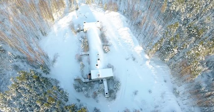 4K Aerial drone footage of an old army bunker located in forest. Winter view.