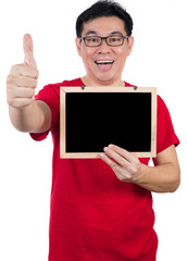 Fototapeta na wymiar Happy Asian Chinese man holding blackboard with thumbs up