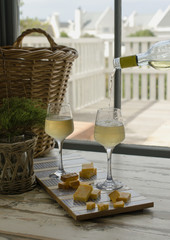 Two glasses of white wine with cheese, rustic, selective focus