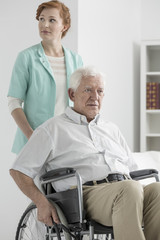 Obraz premium Upset senior on wheelchair