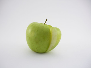 green apple with a slice on white