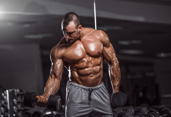 Fototapeta na wymiar Handsome man exercise in gym.