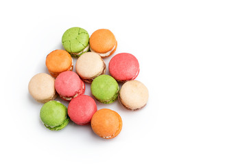 Fototapeta na wymiar Colorful macaroons isolated on white with space for text. Traditional french dessert. Top view, flat lay.