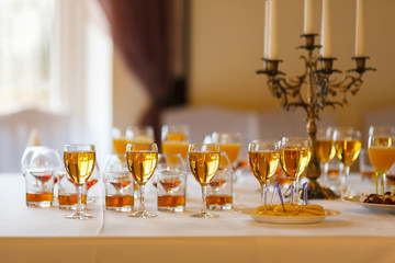 lot of glasses of wine, juice and whiskey on the buffet table