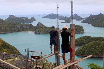 Workers are building on a top of the mountain on the island in Thailand. October 22, 2016 