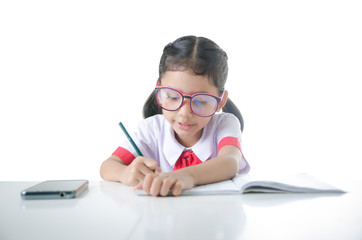 Asian little girl doing homework in Thai Student uniform isolate