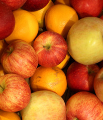 background of ripe apples and oranges orange