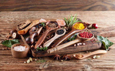 Herbs and spices  on a wooden background