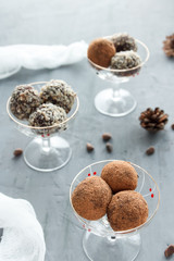 Chocolate candies in glass ice-cream bowls, cones, nuts.