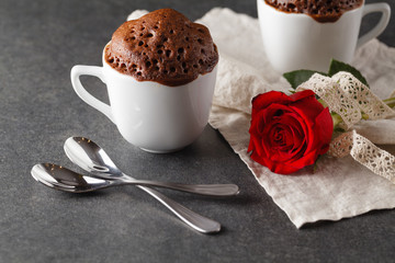 Valentines day table setting with cups, red hearts, ribbon and r