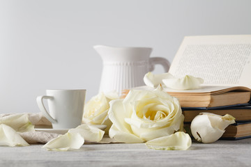 White roses and two white cups