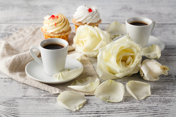 White roses and two white cups