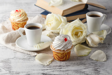 cup of coffee with roses on the wooden background