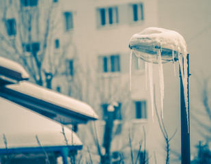 Naklejka na ściany i meble frozen streetlight with icicles on a cold winter day