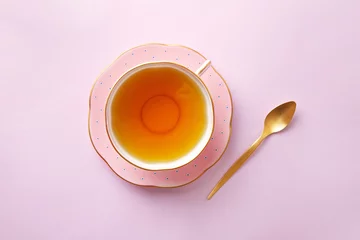 Fotobehang Thee Tea cup on pastel pink background. Top view