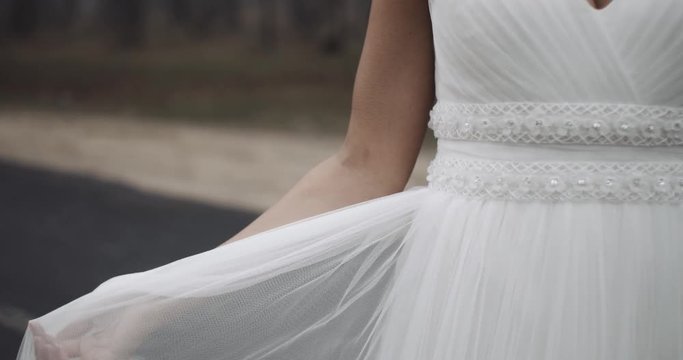 Detail of hand bride in a beautiful wedding dress, slow motion. 4k