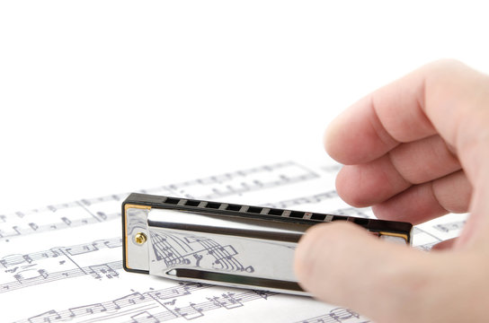 Harmonica musical notes and hand musician