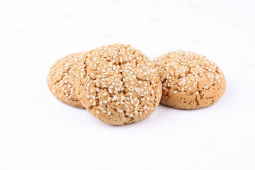 Tasty sweet brown oat cookies on the white cloth on the table in cafeteria or restaurant.