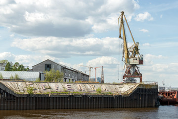 Strelka, Nizhny Novgorod. Port cranes and buildings of the cargo river port. View from the Volga...