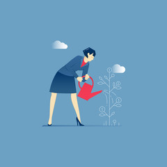 Business woman stands and waters a money tree