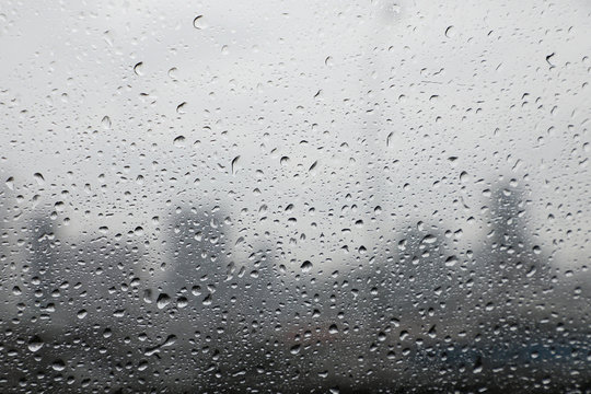 water droplets on mirror with blurred city background