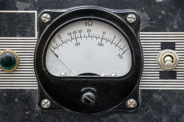 Old measuring instrument with an arrow. Retro dusty analog device