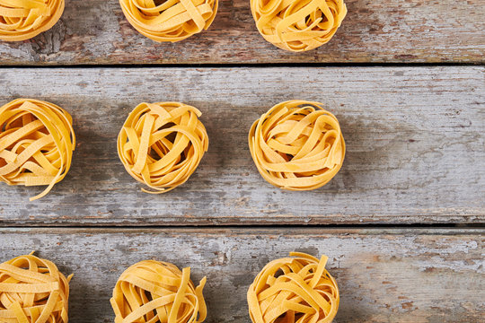 Many balls of pasta on rustic background.