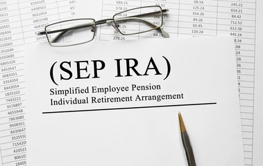 Paper with Simplified Employee Pension Individual Retirement Arrangement (SEP IRA) on a table