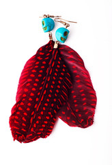 Exotic original red earrings Indian feather speckled isolated on