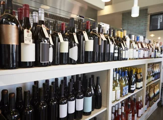 Zelfklevend Fotobehang Bar Bottles Of Wine On Display In Delicatessen