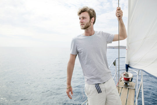 Man standing on sailboat