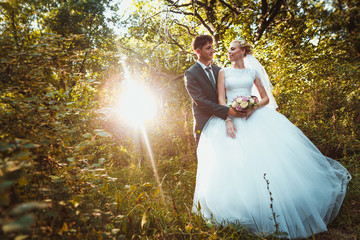 bride and groom on the forest background