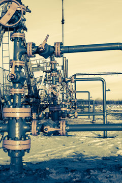 Group of wellhead. Oilfield with sand ground. Oil and gas . Toned.