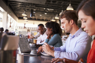 Business People Working At Counter In Coffee Shop