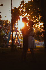 guy and the girl hugging at amusement background