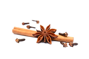 Aromatic star anise, cloves and cinnamon isolated on white background