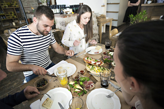 Group of friends having lunch in restaurant