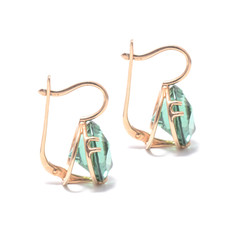 gold earrings with emerald isolated on white