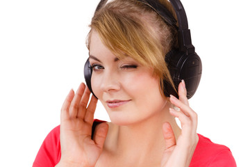 Fototapeta premium Woman in big headphones listening music isolated