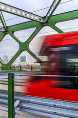 View through the old bridge with tram and skyscapers at sunrise, © Matej Kotula