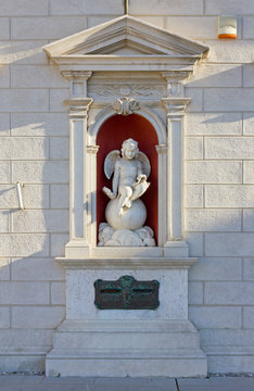 Niche with a Child Angel Sculpture on a Neoclassic Building