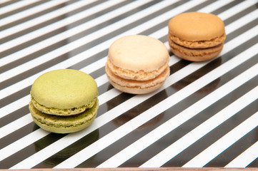 Macaroons close up on a striped background, selection of macaroon flavours