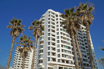Fototapeta na wymiar modern apartment buildings with palm trees