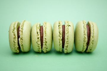 Macaroons close up on a green background, pistachio macaroons