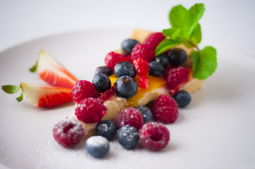 Fruit tart with blueberries, strawberries, raspberries and blackberries. 