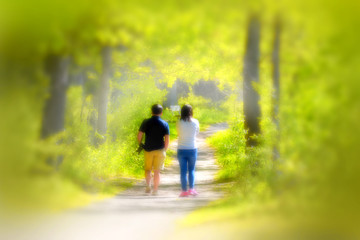 Obraz premium Back view of young couple walking in the park